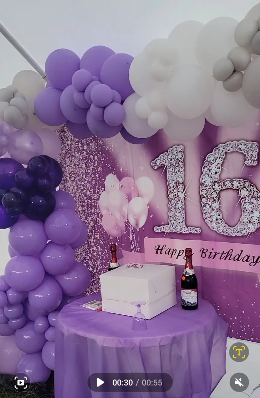 Purple, lavender and white sweet sixteen balloon garland with sequin backdrop and cake table