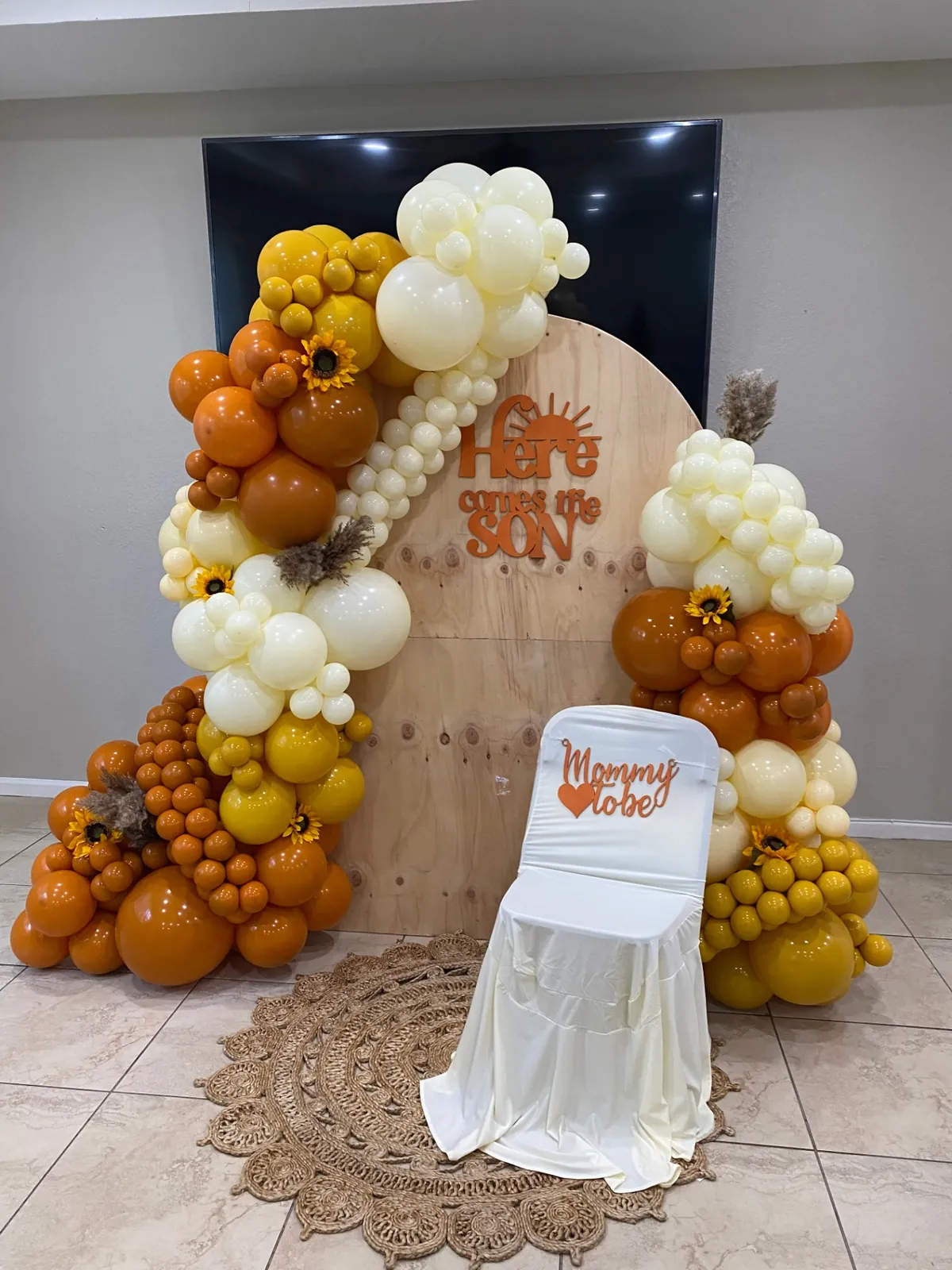 Boho 'Here Comes the Son' baby shower balloon arch in burnt orange, mustard and ivory with sunflowers and pampas, South Florida